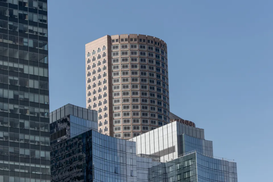 Clean commercial glass windows reflecting a clear sky